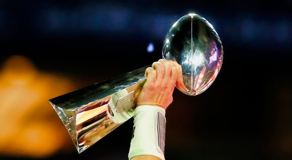 Lombardi trophy being held up in the air.