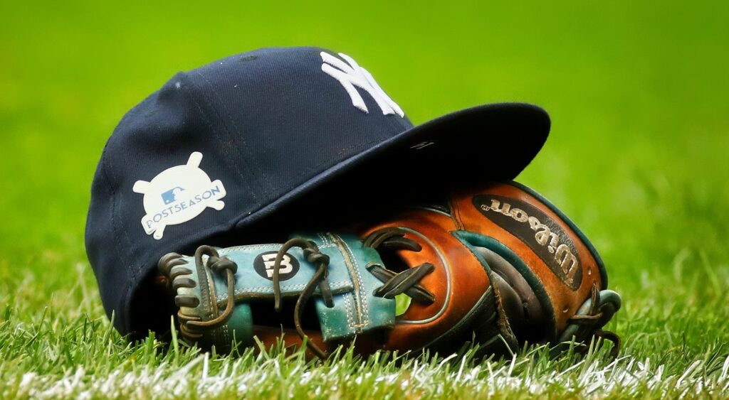 Yankees cap and glove on ground