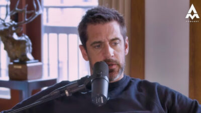 Aaron Rodgers speaking into podcast mic