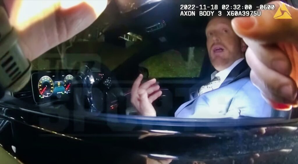 todd downing looking at cop while in car