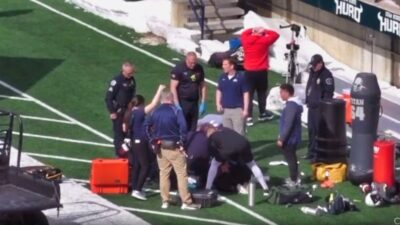 Ut State player surrounded by medical personnel
