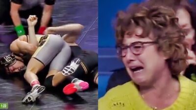 Two wrestlers on ground. Mom in yellow crying in the stands.