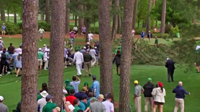 Spectators loking on after trees fall at The Masters