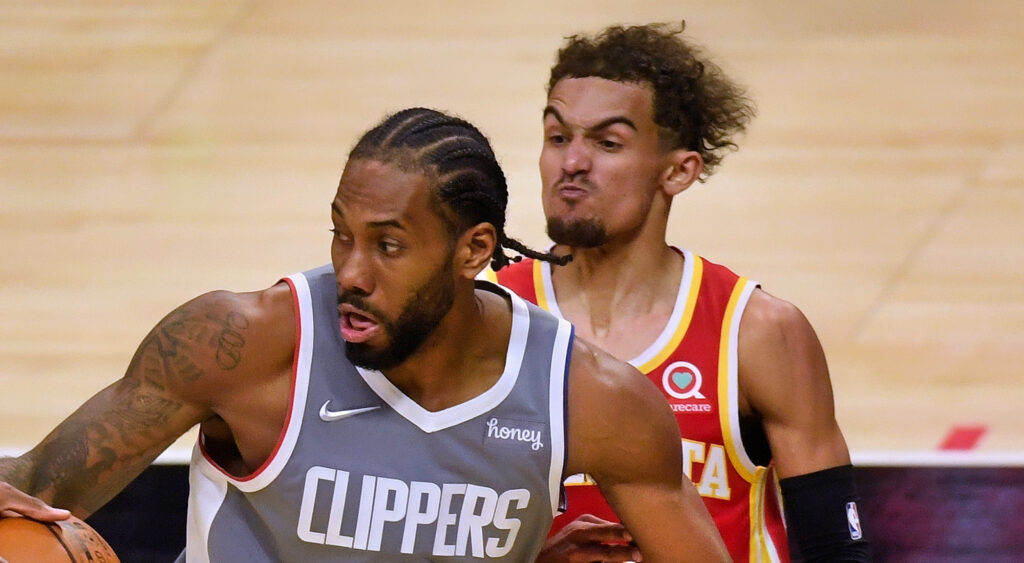 Los Angeles Clippers' star Kawhi Leonard being guarded by Atlanta Hawks' star Trae Young.