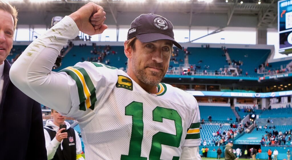 Aaron Rodgers pumps his fist while walking off the field after a win.