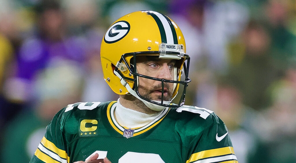 Green Bay Packers' quarterback Aaron Rodgers looking ahead with ball in hands.