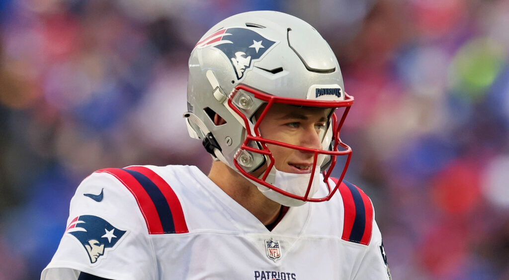 New England Patriots quarterback Mac Jones warming up for 2023 game.