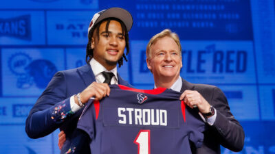 CJ Stroud holding jersey with Roger Goodell