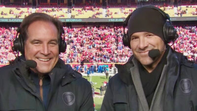 Tony Romo and Jim nantz smiling while on broadcast