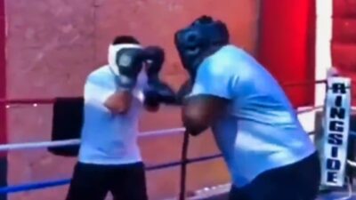 NFL player in boxing ring with another guy