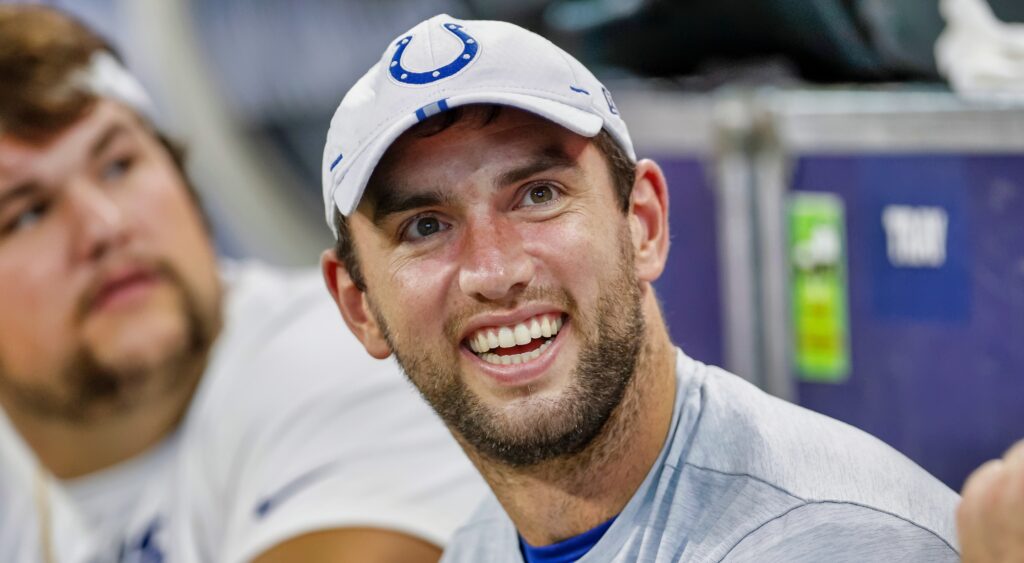 Andrew Luck smiles while on the sideline.