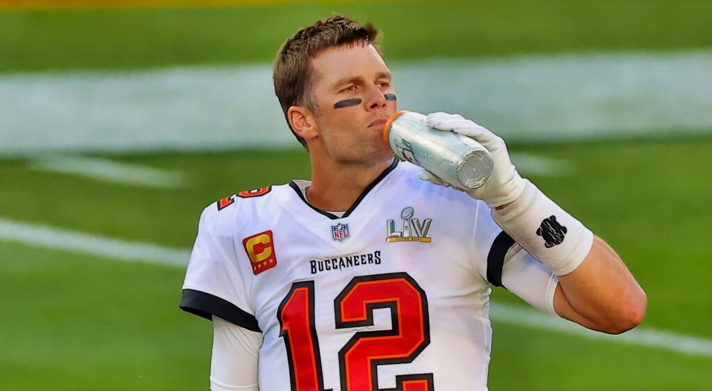 Tom Brady sips on a water bottle before a game.