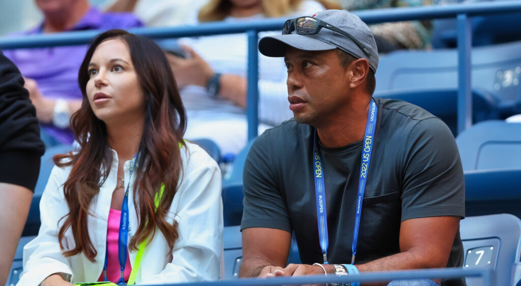 Tiger Woods sitting next to Erica Herman