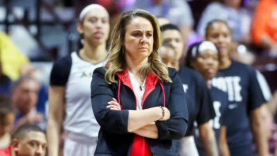 Becky Hammon standing with her arms folded