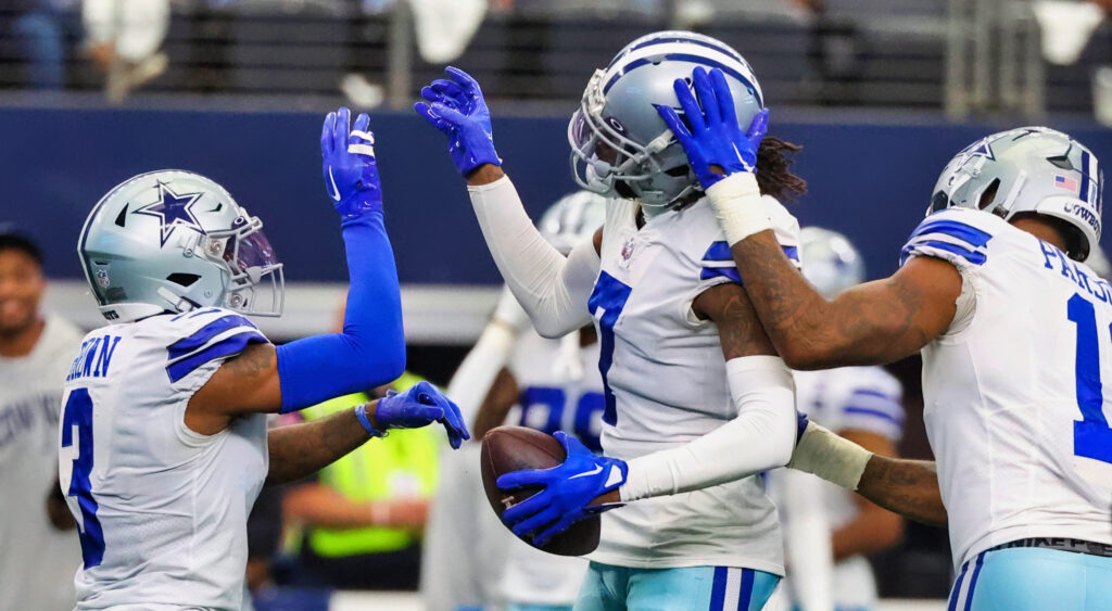 Dallas Cowboys players celebrating after an interception vs. Detroit Lions.