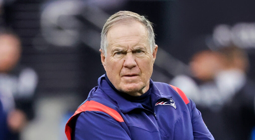 New England Patriots head coach Bill Belichick looking on at Allegiant Stadium.