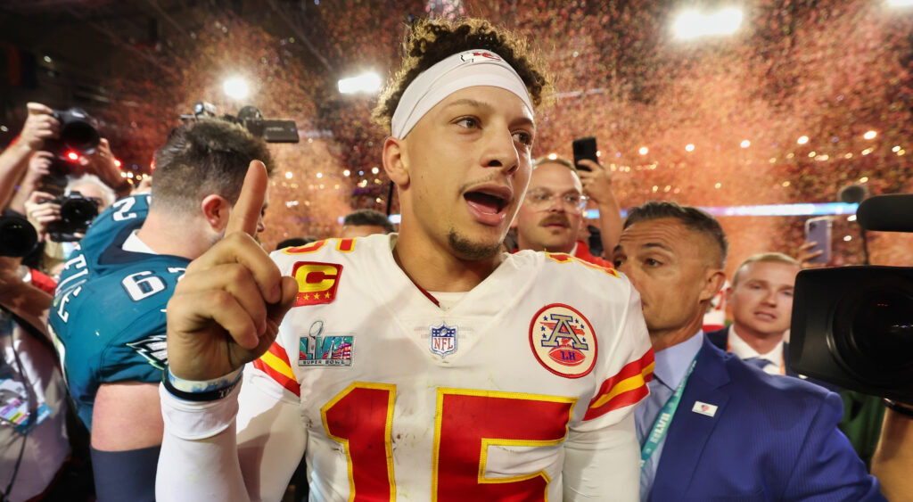 Patrick Mahomes without helmet holding up finger