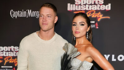 Christian McCaffrey holding Olivia Culpo