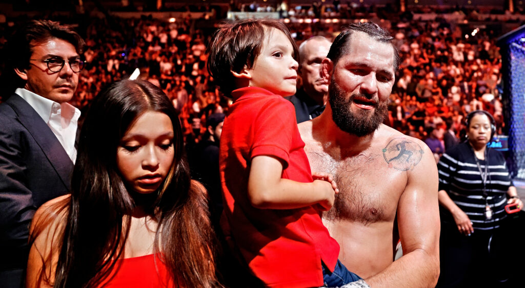 Jorge Masvidal exits the octagon with family.