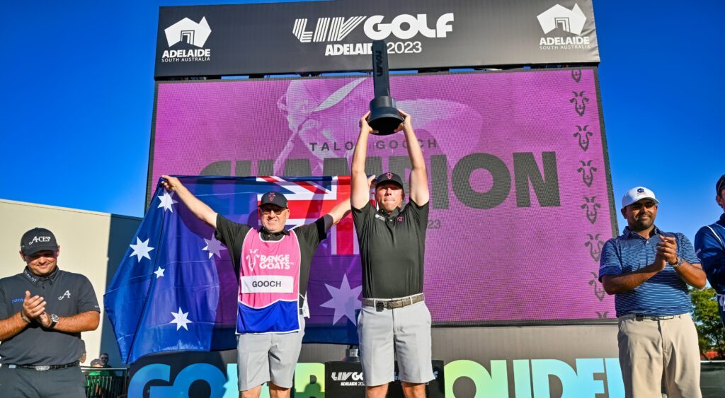 Talor Gooch holds up the trophy after winning a LIV Golf event in Australia.