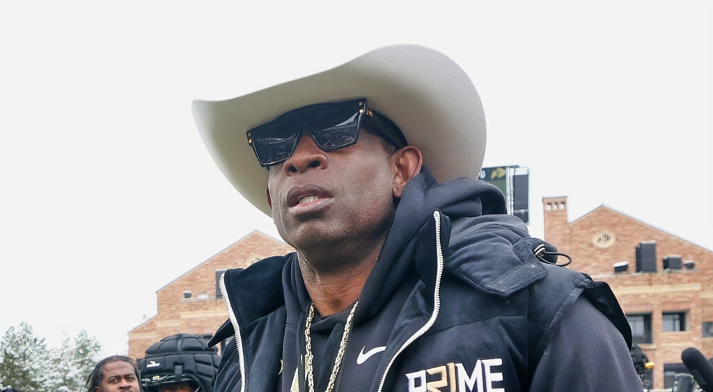 Deion Sanders wearing a cowboy hat and sunglasses