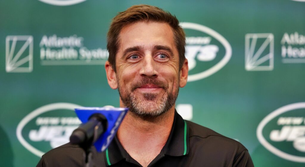 Aaron Rodgers smiles at his press conference with the Jets.