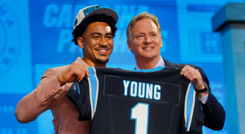Bryce Young holding up jersey with Roger Goodell at 2023 NFL Draft.