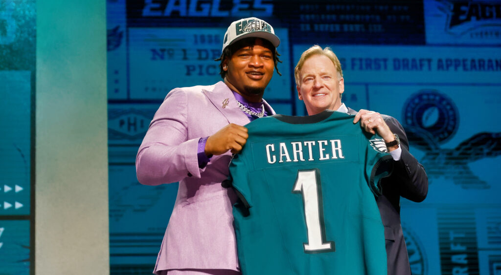 Jalen Carter holding jersey at draft