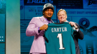 Jalen Carter holding jersey at draft