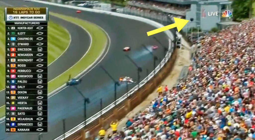 A tire goes flying off a car at the Indy 500.