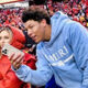 Jackson Mahomes holding cell phone while standing next to sister-in-law Brittany Mahomes