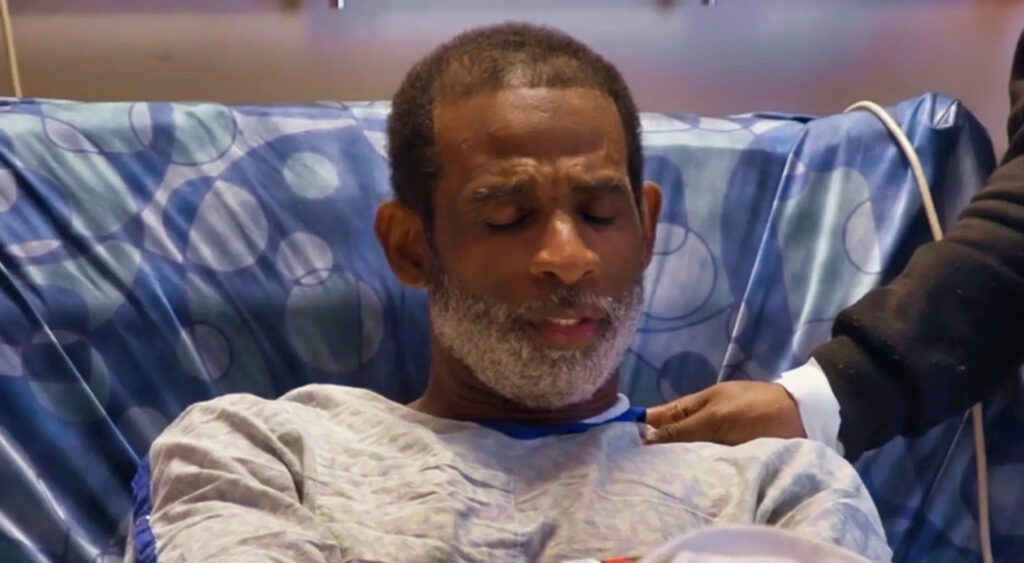 Deion Sanders in a hospital bed