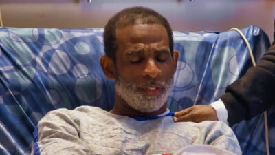 Deion Sanders in a hospital bed