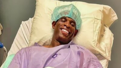 Deion Sanders smiling in ospital gown