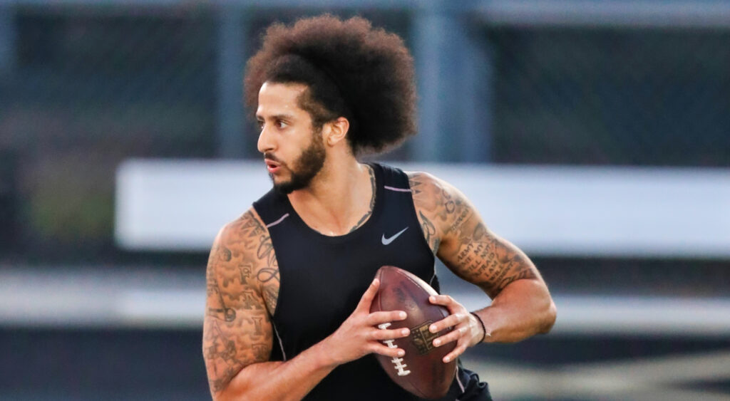 Colin Kaepernick about to throw a football during a workout