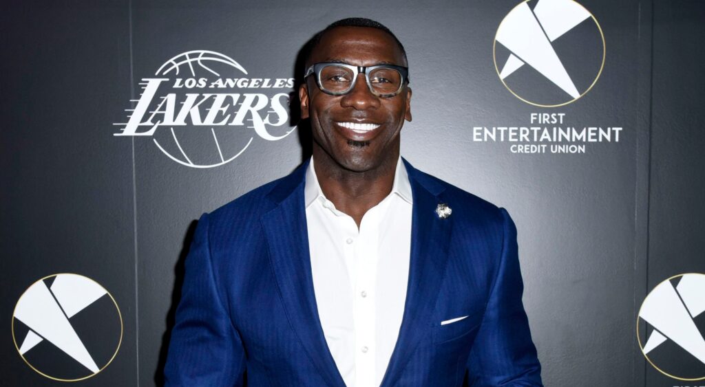 Shannon Sharpe posing in suit