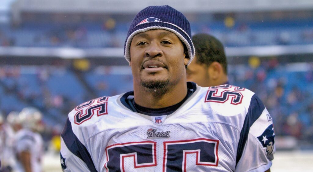 Willie McGinest on the field wearing a winter hat.