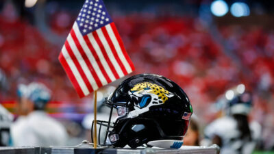 Jaguars helmet next to American flag