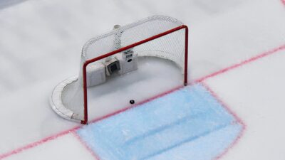 Hockey goal and puck on ice