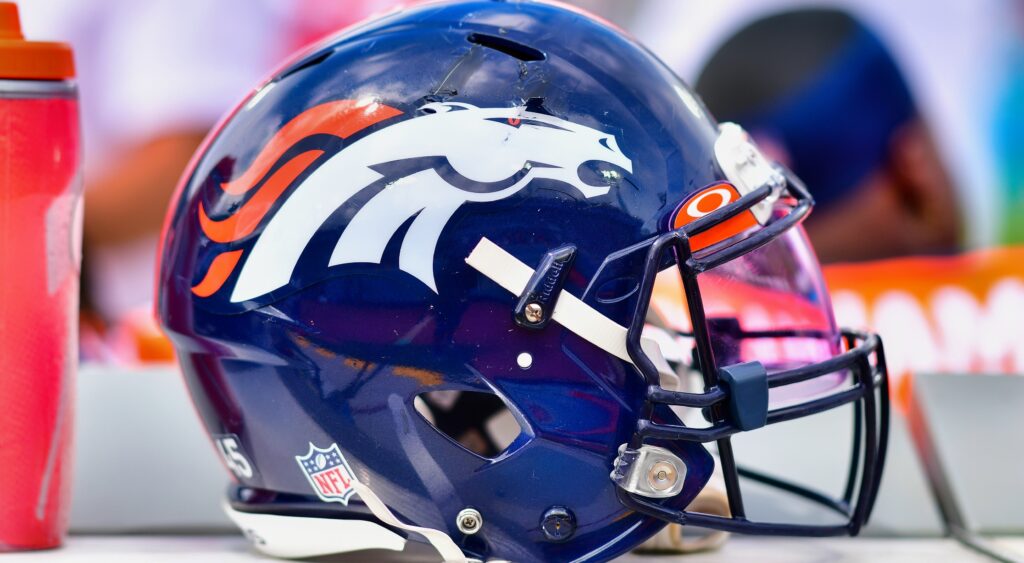 A Denver Broncos helmet on the bench.