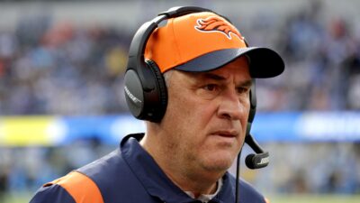 Vic Fangio with headset on and Broncos gear