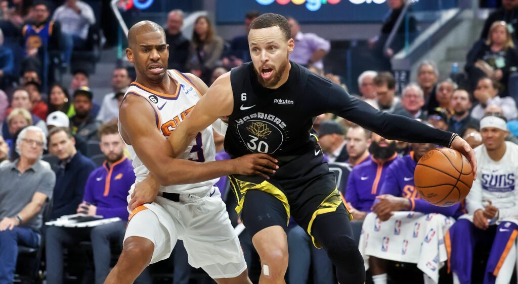 Chris Paul of Phoenix Suns (left) guarding Stephen Curry of Golden State Warriors (right).