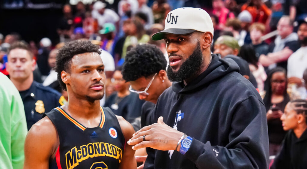 Bronny James (left) speaking to father LeBron James (right).