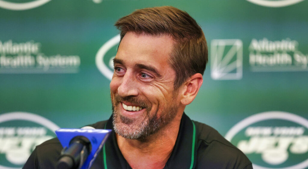 Aaron Rodgers of New York Jets smiling during press conference.