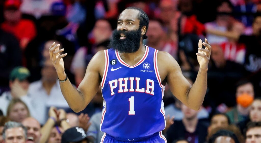 James Harden holds his arms up during a game.
