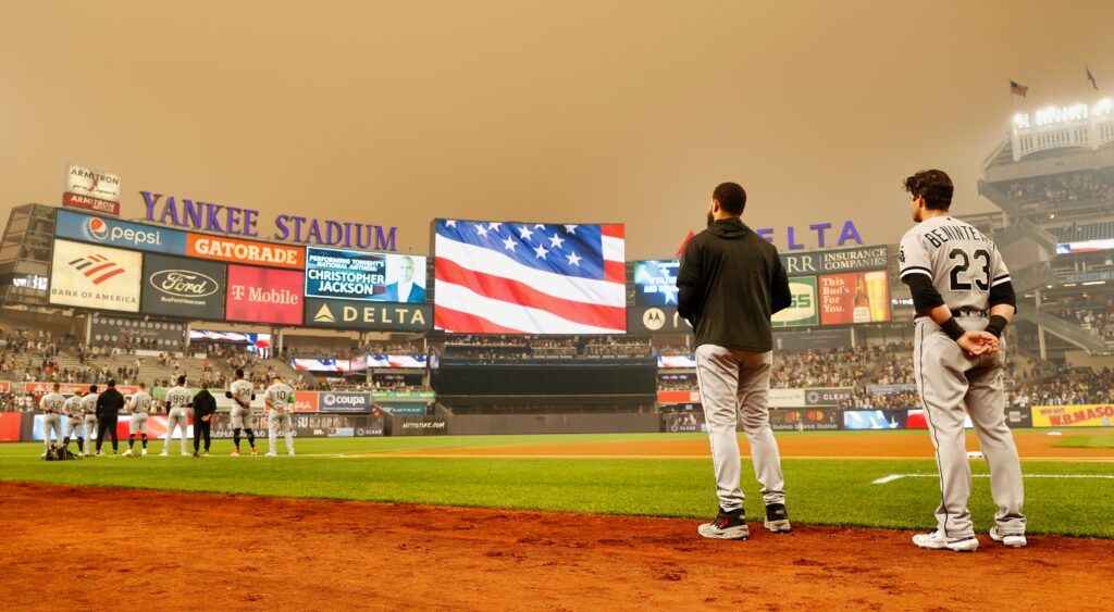 White Sox players stand for the national anthem at Yankee Stadium.