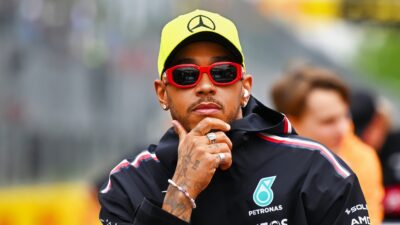 Lewis Hamilton with a hand on his chin