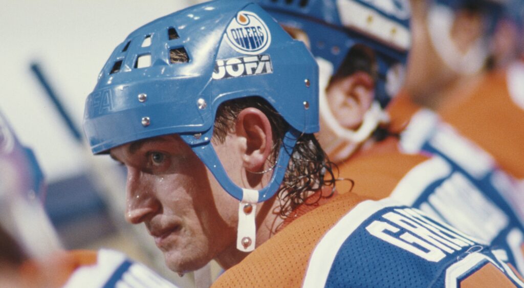 Edmonton Oilers' legend Wayne Gretzky sitting on bench during 1987 game.