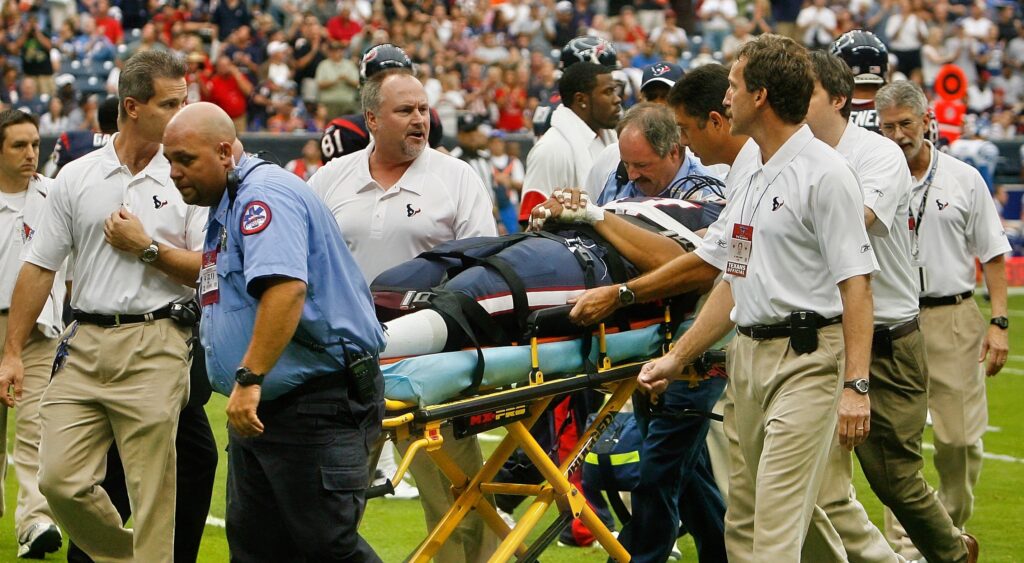 Cedric Killings being stretchered of field surrounded by medical personal