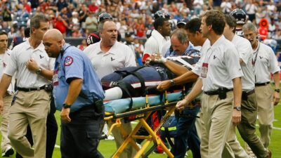 Cedric Killings being stretchered of field surrounded by medical personal